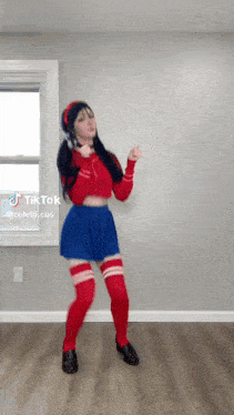 a woman in a costume is dancing in a room .
