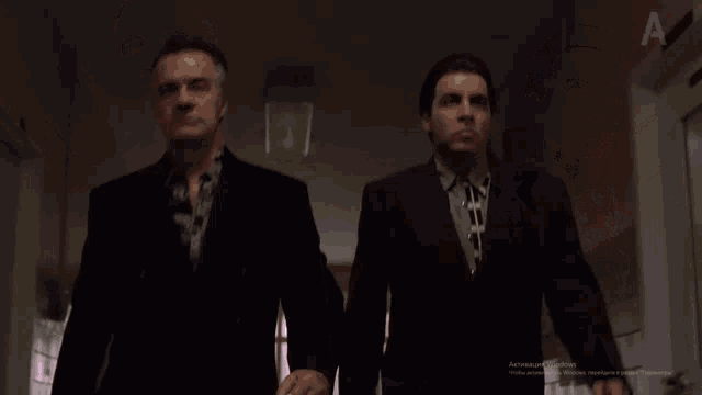 two men in suits are standing next to each other in a hallway and the screen says " activate windows "
