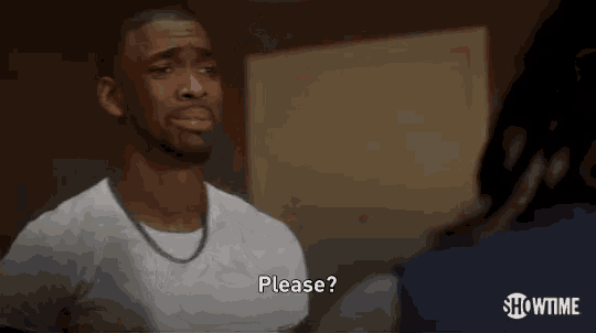 a man wearing a white shirt and a chain is asking for something .