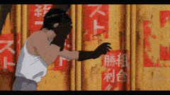 a man is standing in front of a wall that has chinese writing on it