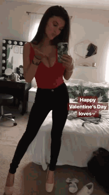 a woman taking a picture of herself in a bedroom with the words happy valentine 's day loves