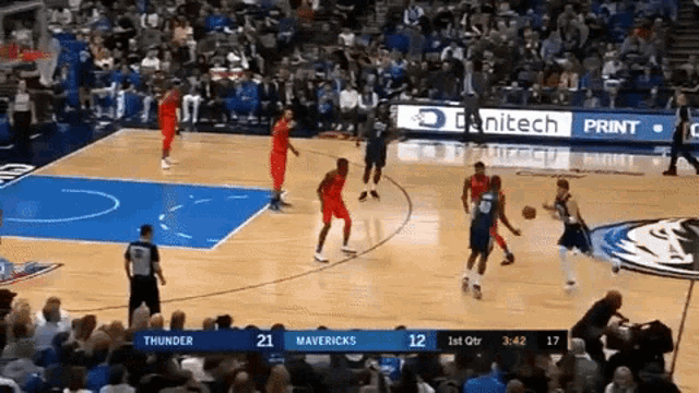 a basketball game being played between the thunder and the mavericks