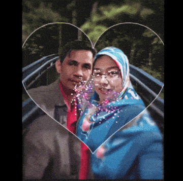 a man and a woman are posing for a picture in front of a heart shaped frame