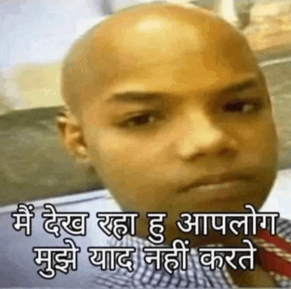 a man with a bald head and a tie is making a funny face in a foreign language .