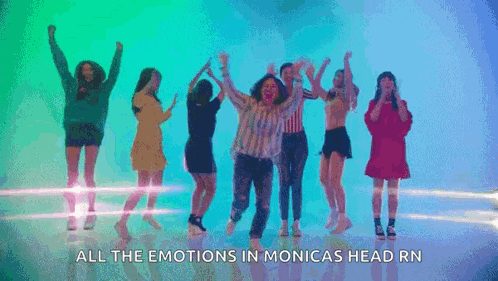 a group of women are dancing together in front of a blue background .