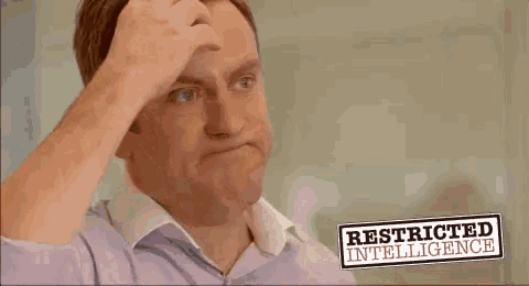 a man in a purple shirt is standing in front of a sign that says restricted intelligence .