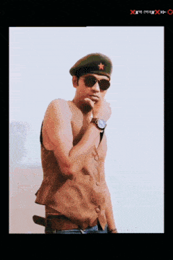 a man wearing sunglasses and a military hat with a red star