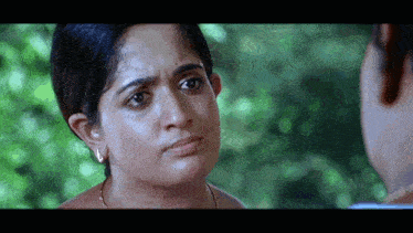 a close up of a woman 's face looking at a man