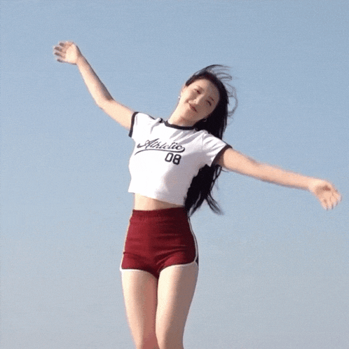 a woman wearing a white athletic 08 shirt
