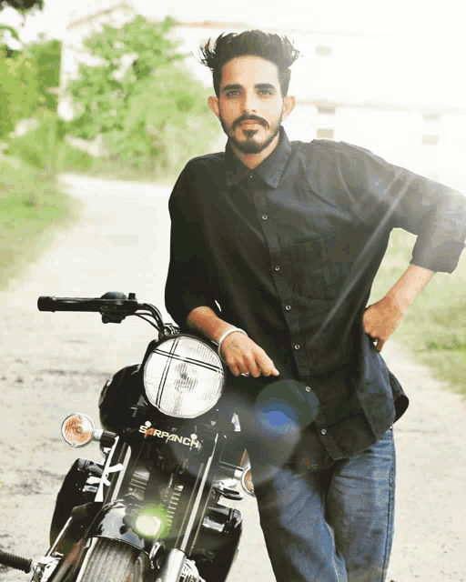 a man in a black shirt stands next to a motorcycle that says earpunch on the front