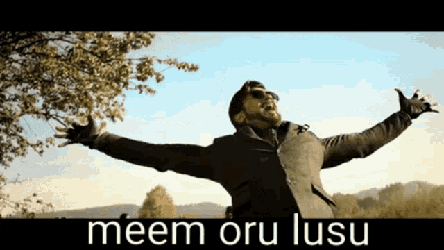 a man with his arms outstretched and the words meem oru lusu behind him