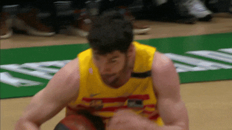 a basketball player wearing a yellow jersey that says nike