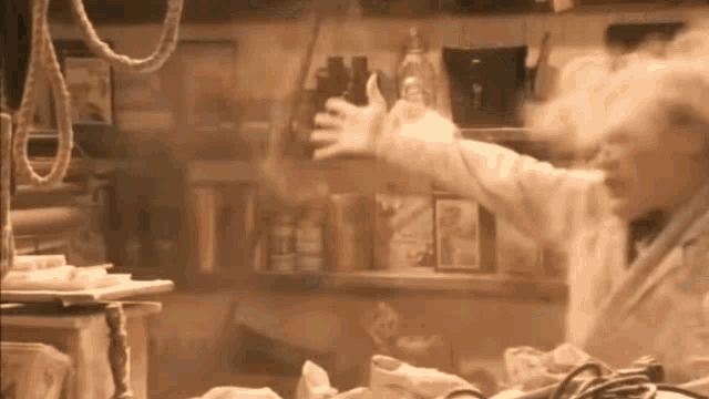 a man in a lab coat is standing in a room with smoke coming out of his hand