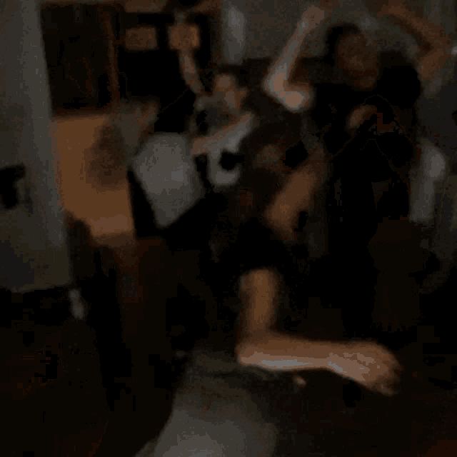 a group of people are dancing in the dark