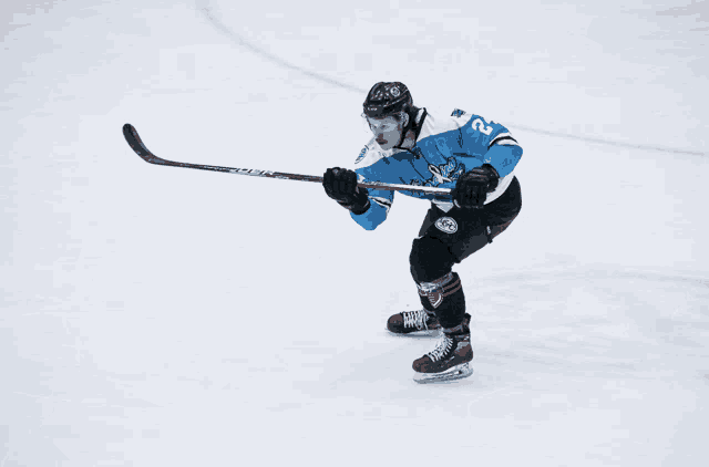 a hockey player in a blue and white jersey with the number 23 on it