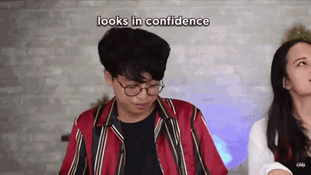 a man wearing glasses looks in confidence while a woman looks on