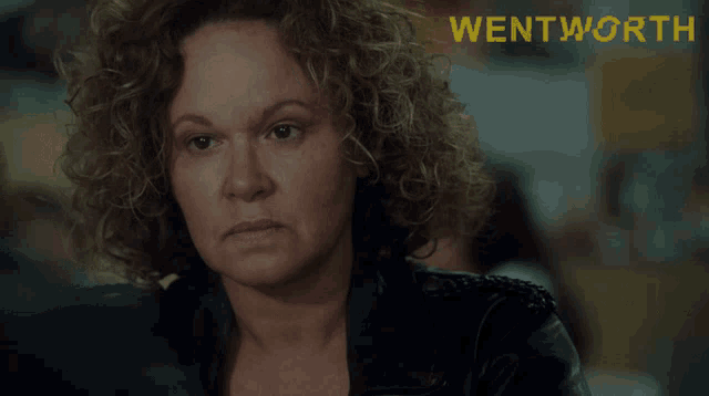 a woman with curly hair has the words blood for blood written on her face