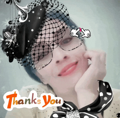 a woman wearing a hat and glasses is surrounded by a thank you sign