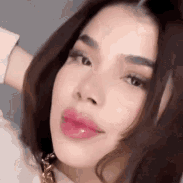 a close up of a woman 's face with a pink lip .