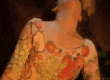 a close up of a woman 's neck and chest in a floral shirt