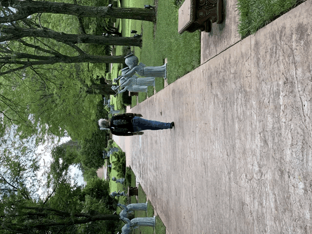 a man walking down a sidewalk with a backpack on