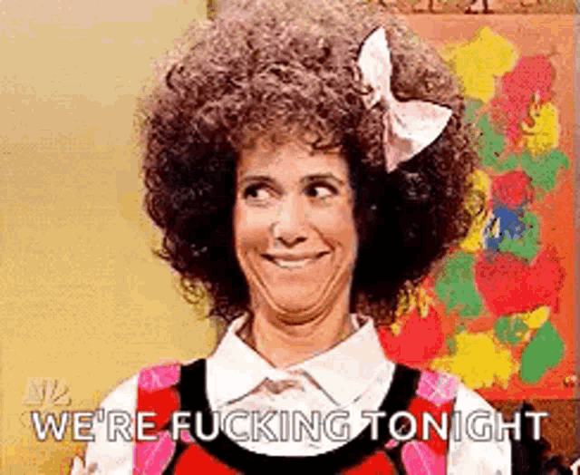 a woman with an afro and a bow in her hair is making a funny face and saying we 're fucking tonight .