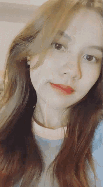 a close up of a woman 's face with long brown hair