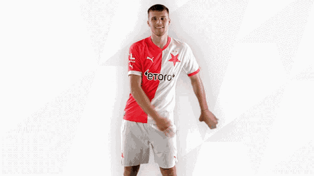 a man in a red and white jersey with etoro on the front