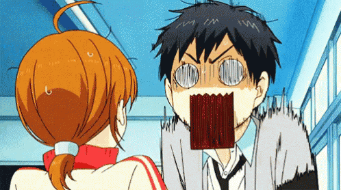a man and a woman are standing next to each other in a hallway and the man is making a surprised face .