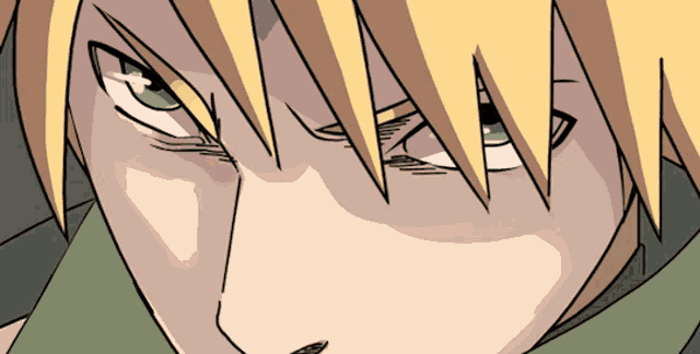 a close up of a cartoon character 's face with yellow hair and green eyes