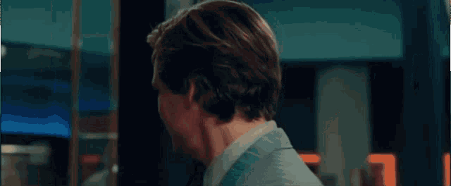 a close up of a man 's face in a suit and tie making a funny face .
