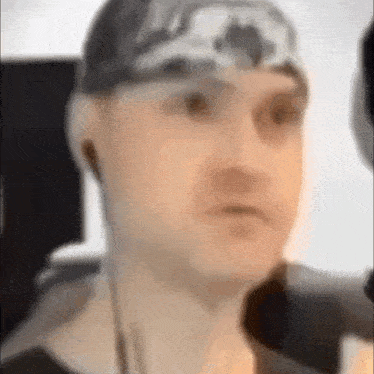 a close up of a man wearing headphones and a headband .