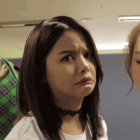 a woman with a choker around her neck makes a sad face