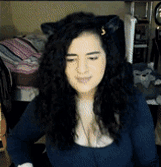 a woman wearing a cat ear on her head is smiling