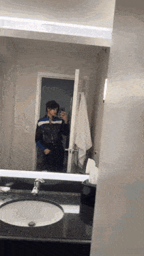 a woman taking a picture of herself in a mirror