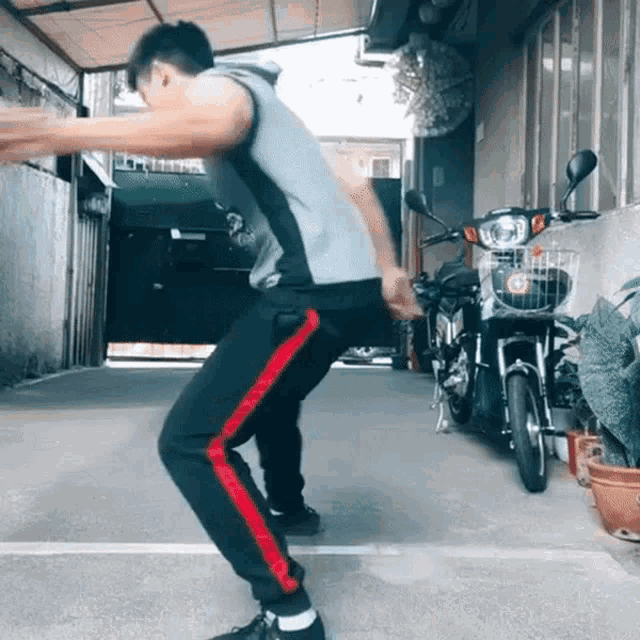 a man squatting in front of a motorcycle with a basket on it