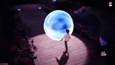 a video game screen shows a person standing in front of a glowing ball