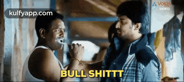 two men are talking to each other and one of them is brushing his teeth while the other is drinking milk .