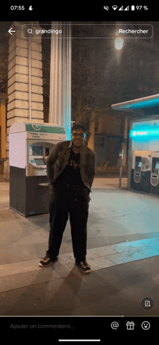 a man standing in front of an atm machine with the word grandingo on it