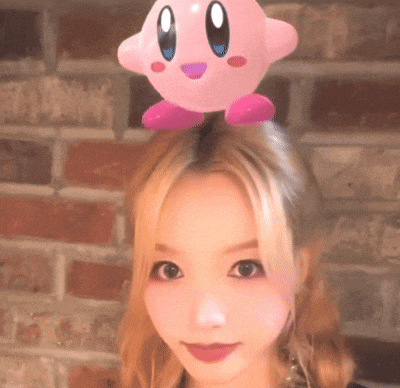 a girl with a pink kirby on her head