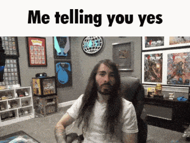 a man with long hair is sitting in a chair with the words me telling you yes written above him
