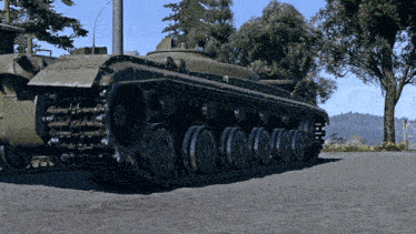 a tank is parked on the side of a road with trees in the background