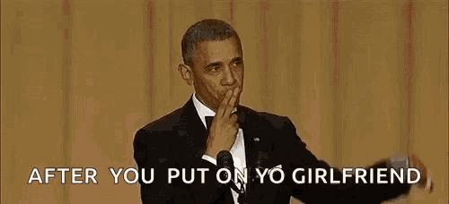 barack obama is giving a speech at an event and covering his mouth with his hand .