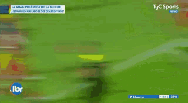 a group of soccer players are playing a game on a soccer field sponsored by tyc sports