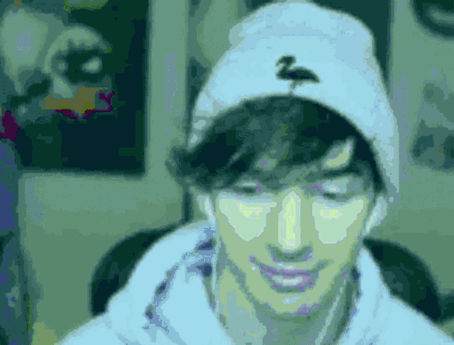 a man is wearing a white hat with a flamingo on it