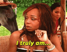 a woman says i truly am while sitting in a wicker chair