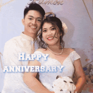 a bride and groom pose for a picture with the words happy anniversary behind them