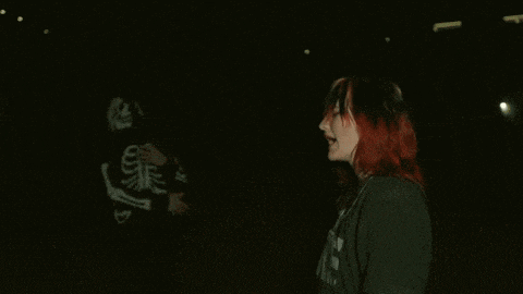 a girl with red hair is wearing a black shirt that says the
