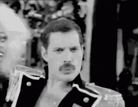 a black and white photo of freddie mercury with a mustache .