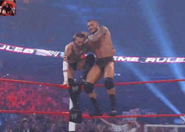 two wrestlers in a ring with the word extreme on the rope